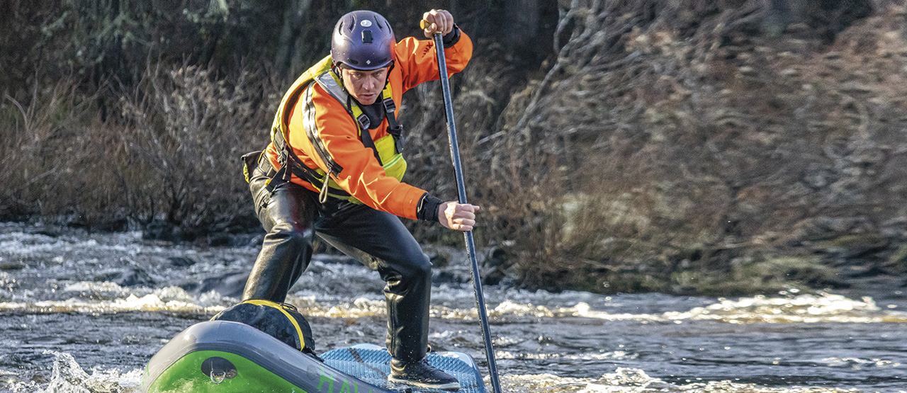 Cross deck paddler Jim Miller. Photographer Eleri Spencer, demonstrating a cross deck for a ww SUP coach training course
